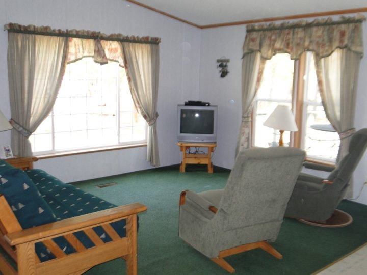 Cozy living room with recliner chairs and CRT television