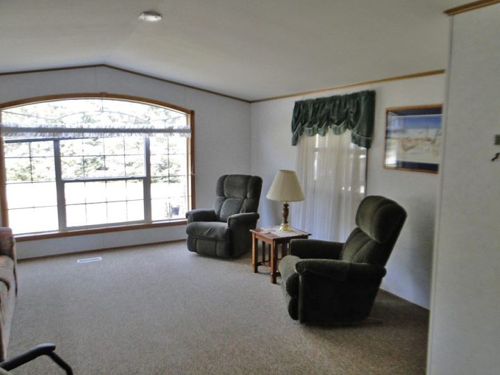 Cozy living room with two green recliners and large window