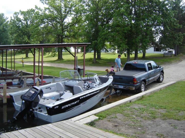 Starcraft boat being launched at lake boat ramp