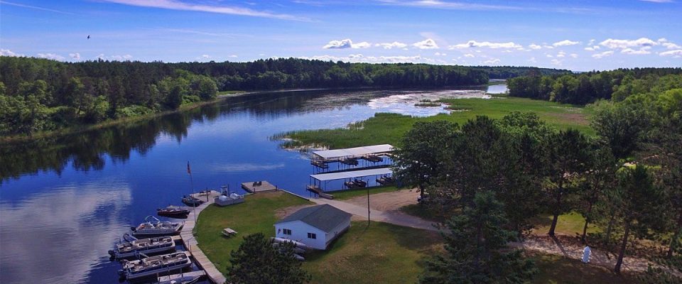 Aerial view of lakeside marina with docks and boats
