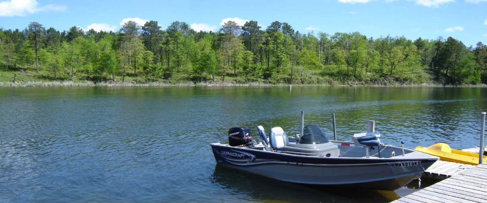 Ultracraft fishing boat docked on calm Minnesota lake