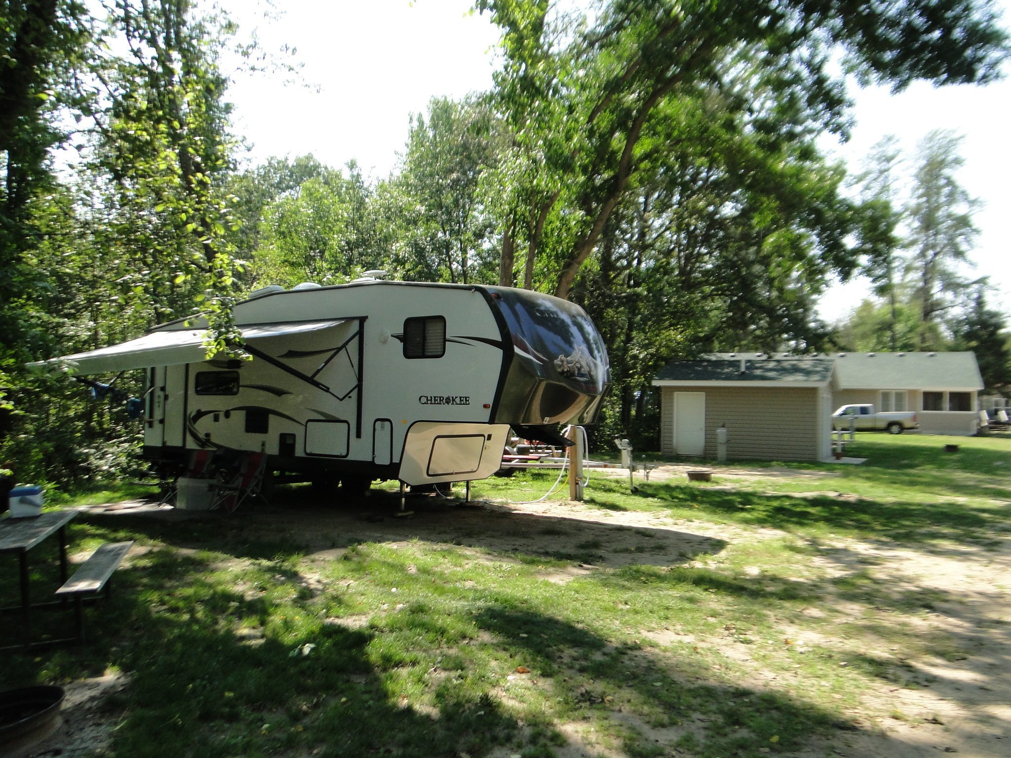 Cherokee fifth-wheel RV parked at shaded campground site
