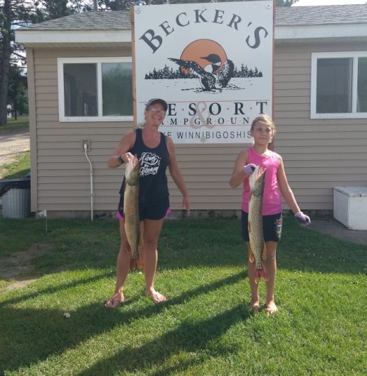 Woman and girl holding large pike at Becker's Resort